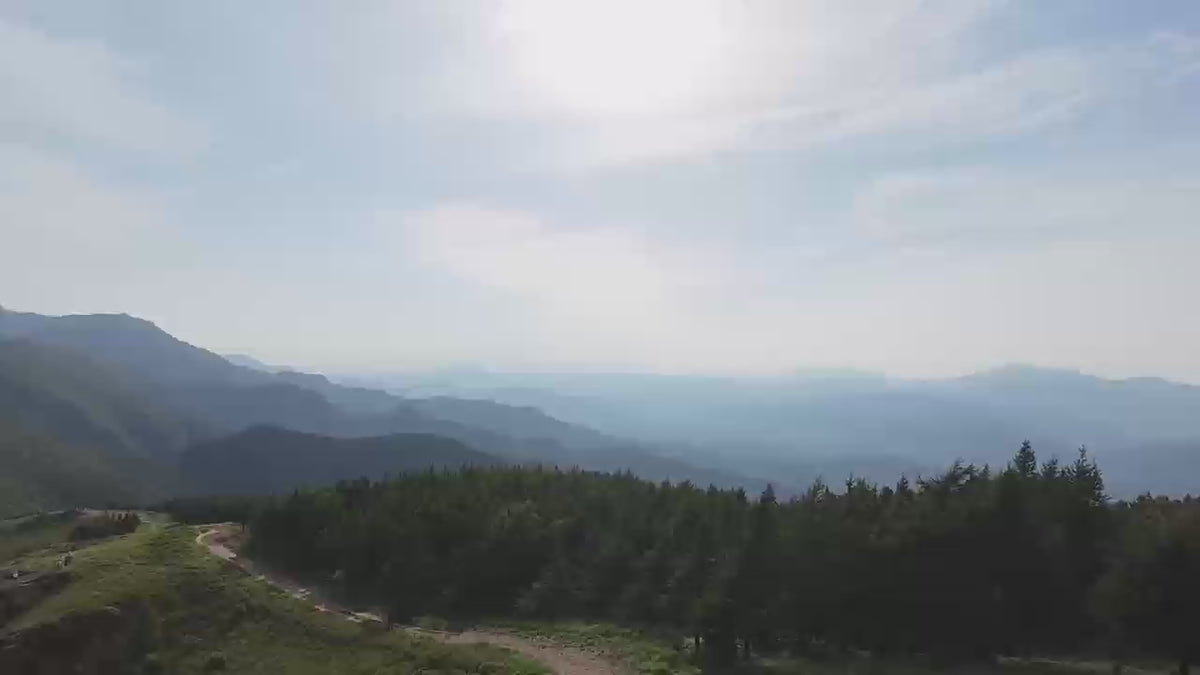 Load video: Young rider in full gear on a silver Evoltrix X7 lightweight aluminum electric dirt bike on an off-road trail.